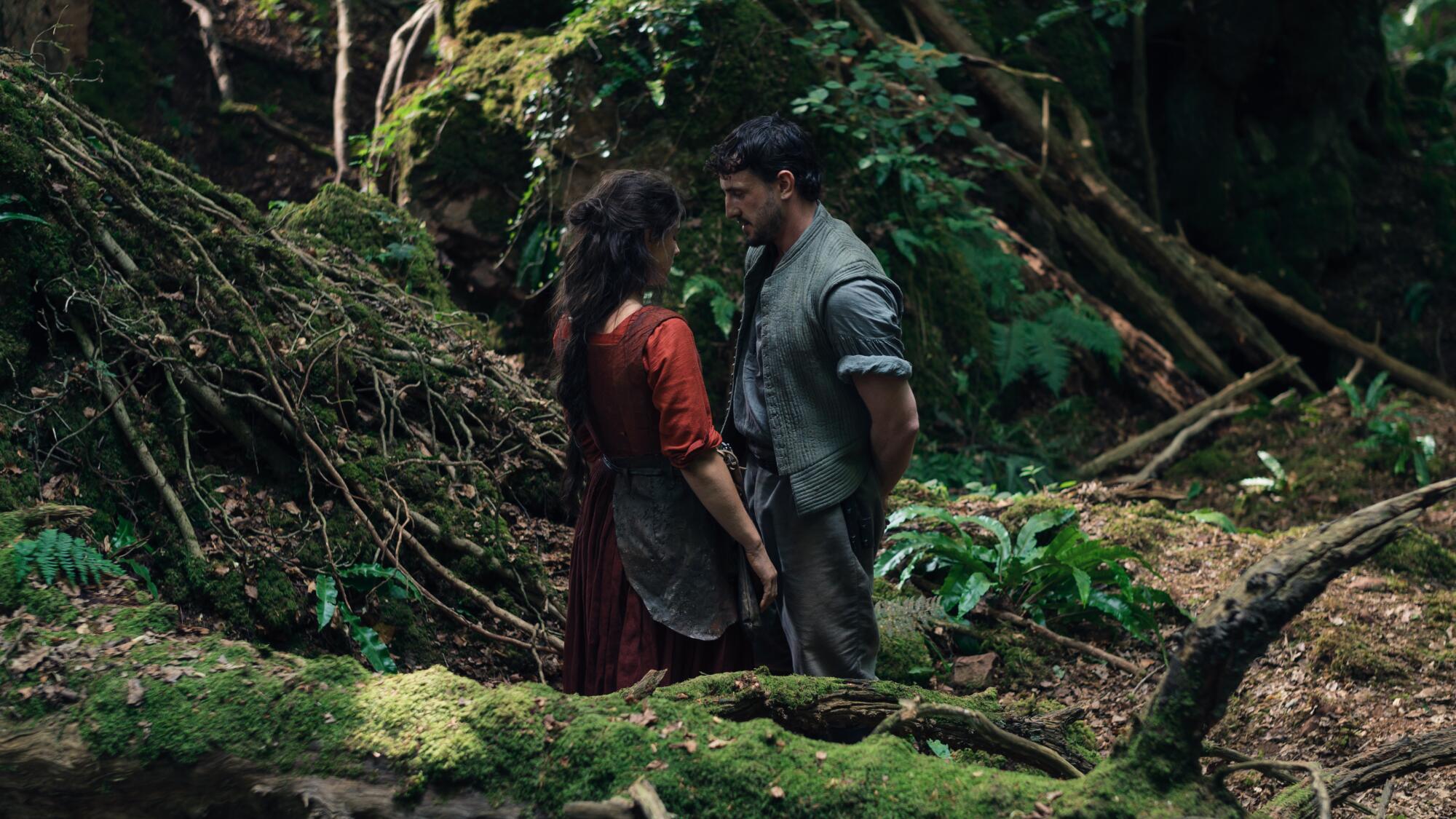 Two lovers approach in the woods.