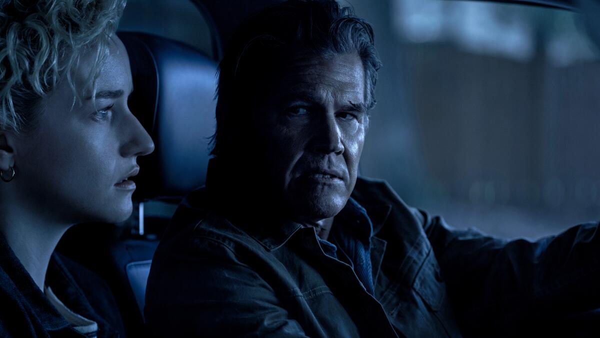 (L-r) JULIA GARNER as Justine and JOSH BROLIN as Archer in New Line Cinema's "Weapons," 
