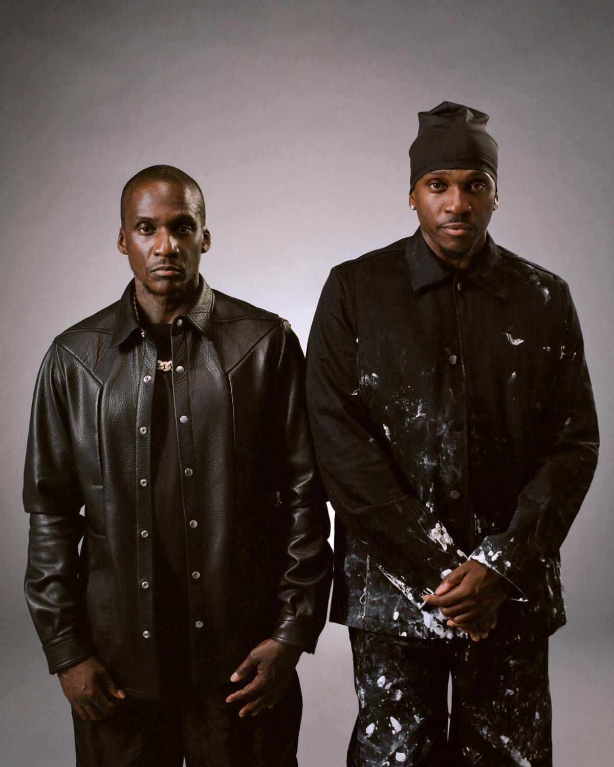 Malice and Pusha T of Clipse pose for a photo while wearing all black.