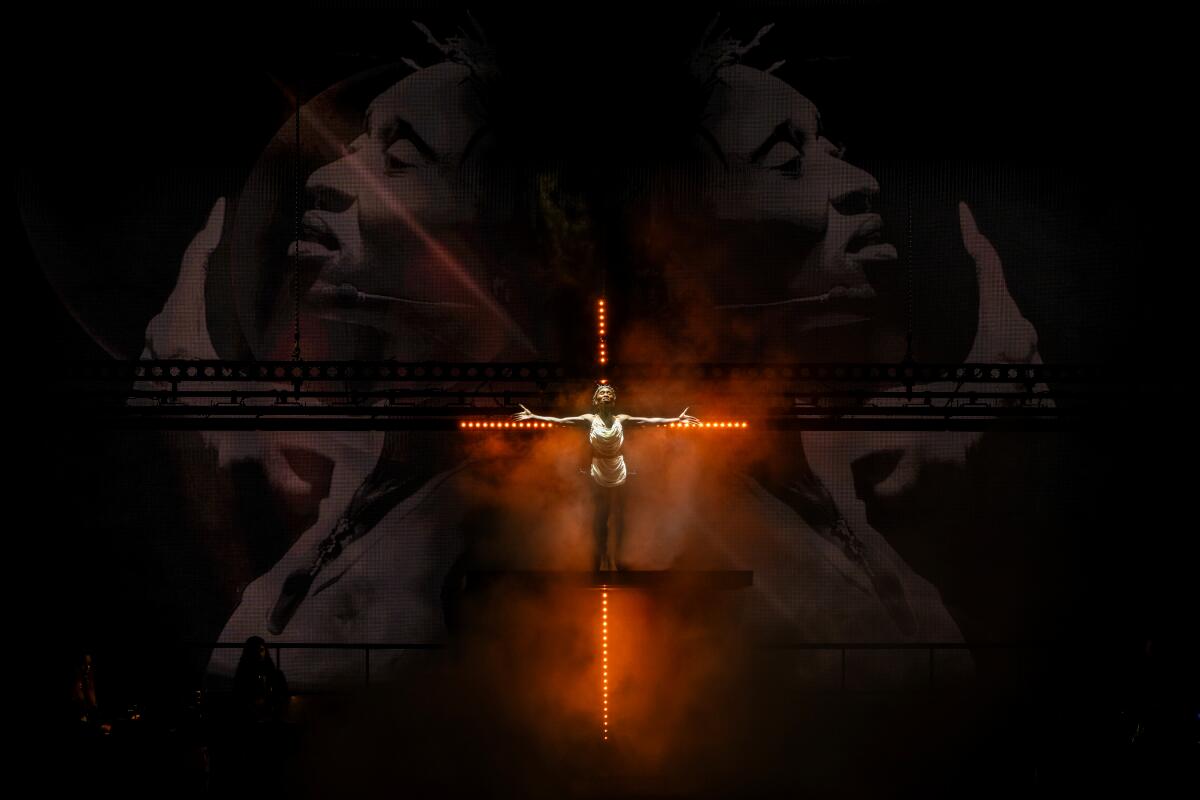 Cynthia Erivo as Jesus stands on an illuminated crucifix in "Jesus Christ Superstar."