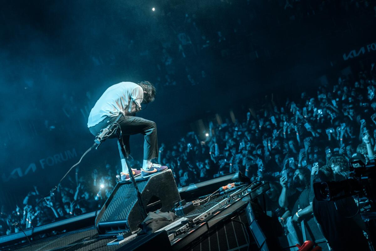 A singer perfoming in front of a large crowd.