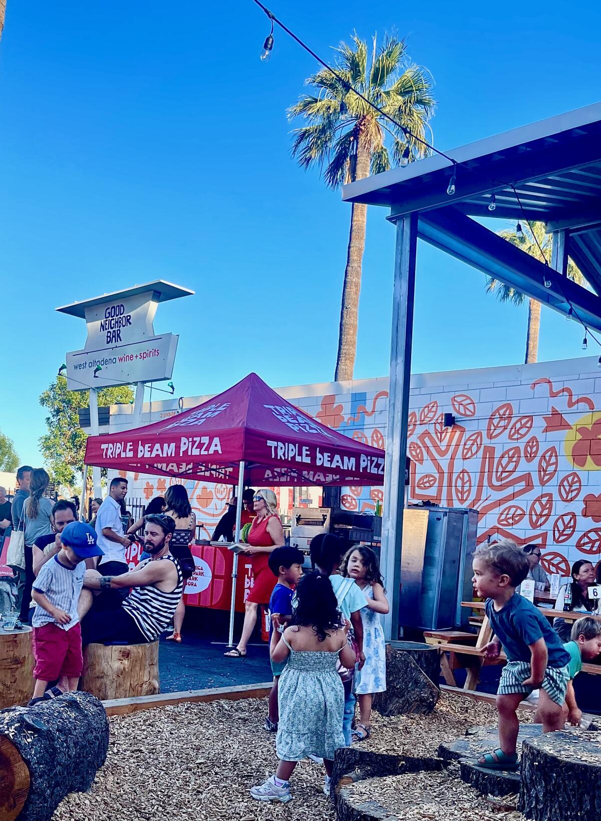 Families enjoying Triple Beam Pizza during Good Neighbor Bar and West Altadena Wine + Spirits pop-up series.
