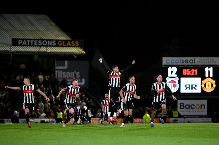 Players of Grimsby Town celebrates victory during the Carabao Cup Second Round match between Grimsby Town and Manchester United