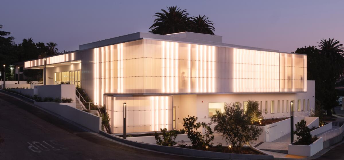 A white building illuminated from outside. 
