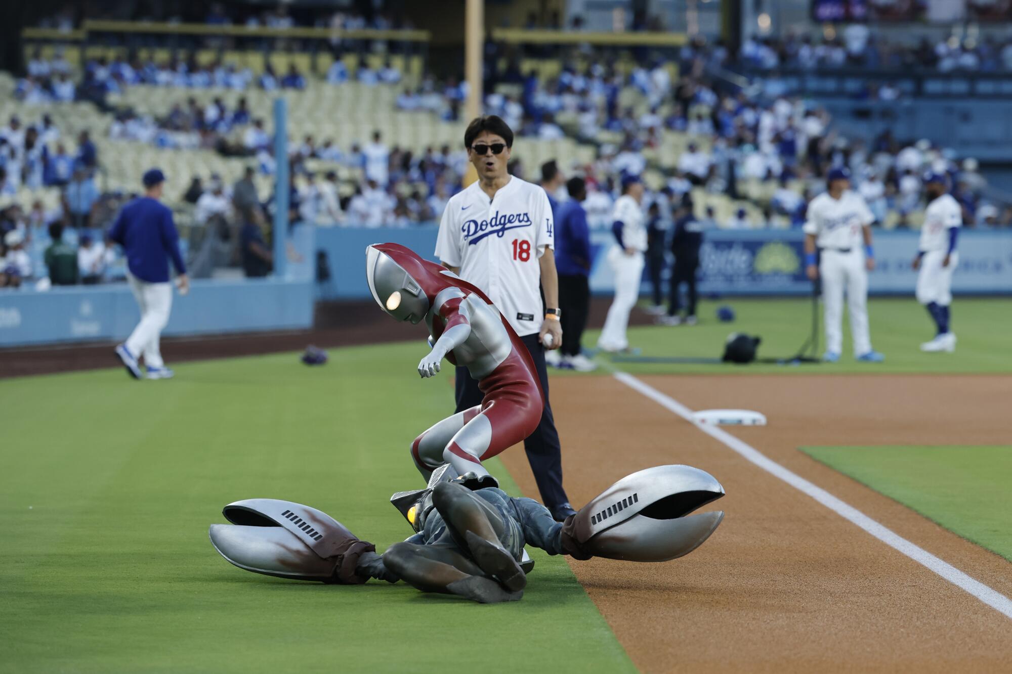 Ultraman takes down Alien Baltan before before the ceremonial first pitch on Tuesday night at Dodger Stadium.