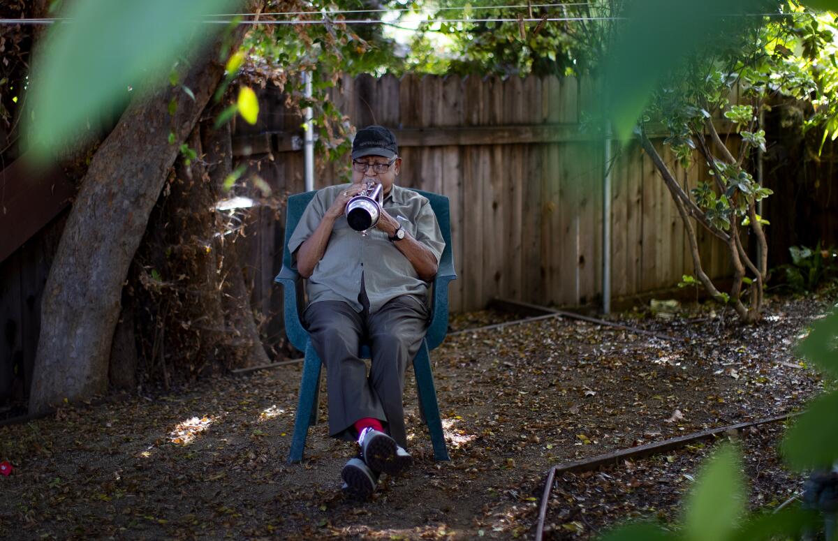 Bobby Bradford plays the cornet while rehearsing his original composition in his Altadena home in 2019.