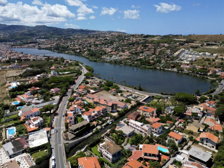 A drone view shows Lake Ganzirri, part of the planned site for the construction of a suspension bridge along the Strait of Messina, connecting Sicily to mainland Italy, with construction expected to be completed by 2032, in Messina, Italy, August 5, 2025. REUTERS/Yara Nardi TPX IMAGES OF THE DAY