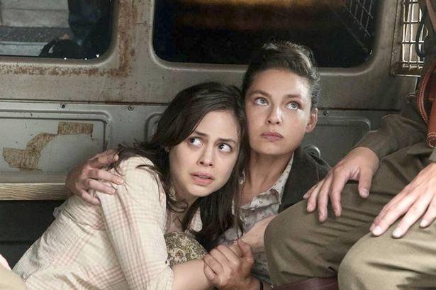 Two women look scared as they are discovered