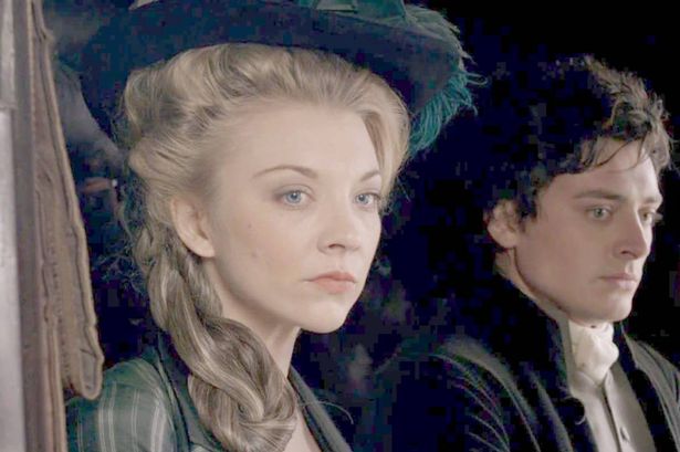 A woman and a man look sad in a carriage