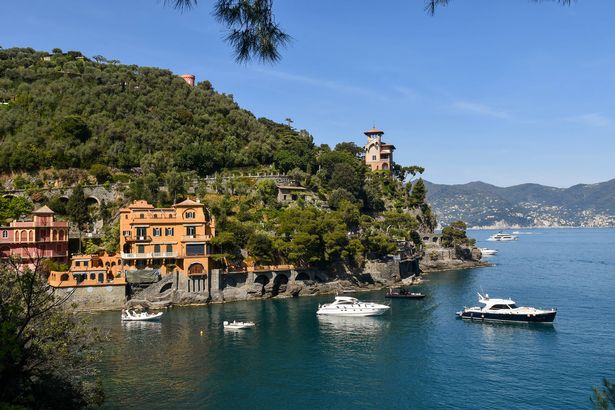Portofino, Genoa, Liguria, Italy - 04/15/2022: Baia Cannone is a small bathing bay with a pebble beach, surrounded by steep cliffs dotted with colorful villas, a short distance from the "Piazzetta" of Portofino.
