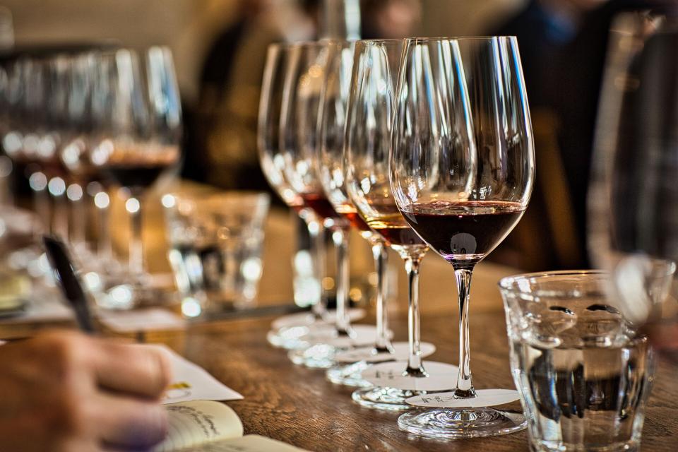 Sommelier evaluating port wine at a tasting.