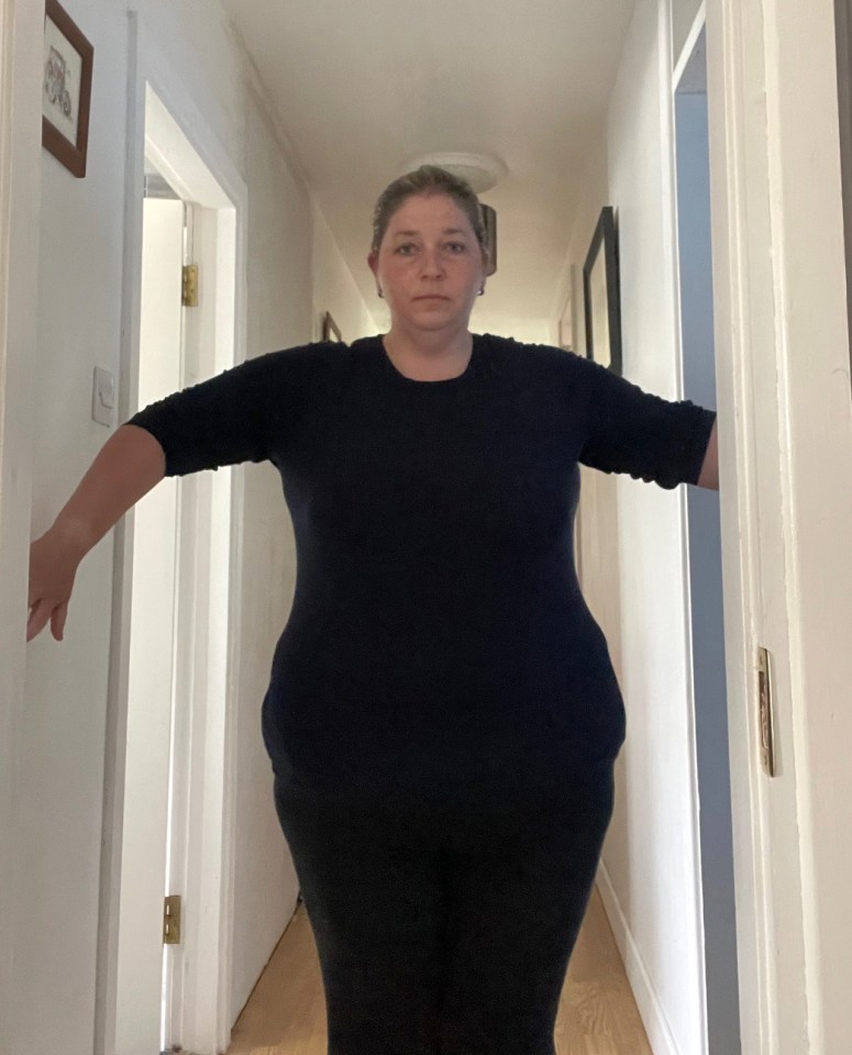 Woman standing in a hallway.