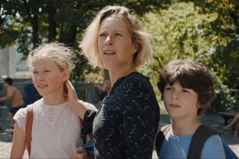 Film still from The Courageous, showing a woman with two children.