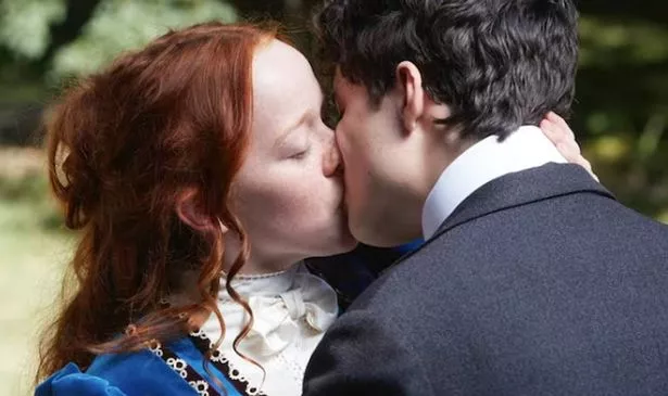 A boy and a girl kiss