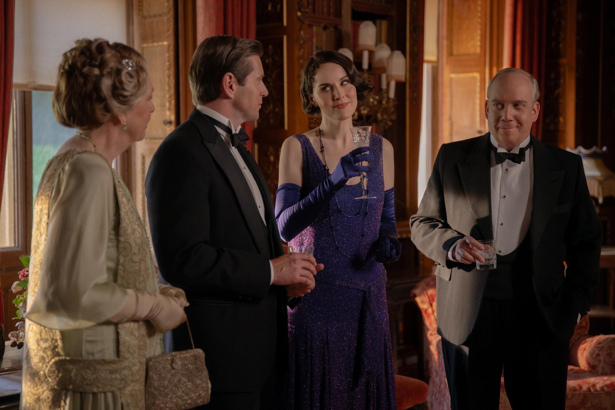 Several Downton denizens swap banter during cocktails.