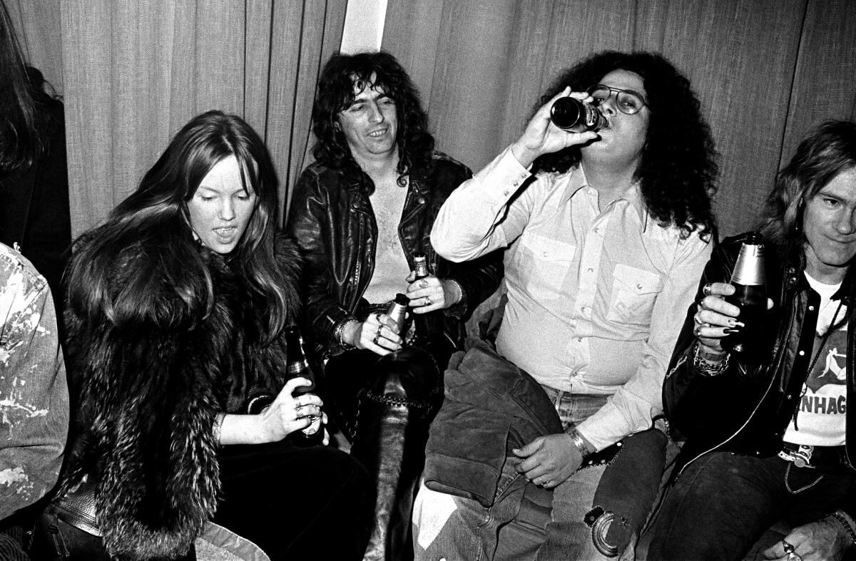 Rock bandmates drinking beer in early 1970s.