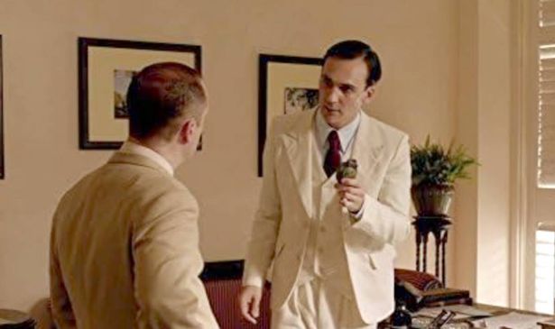 Two men in suits talk