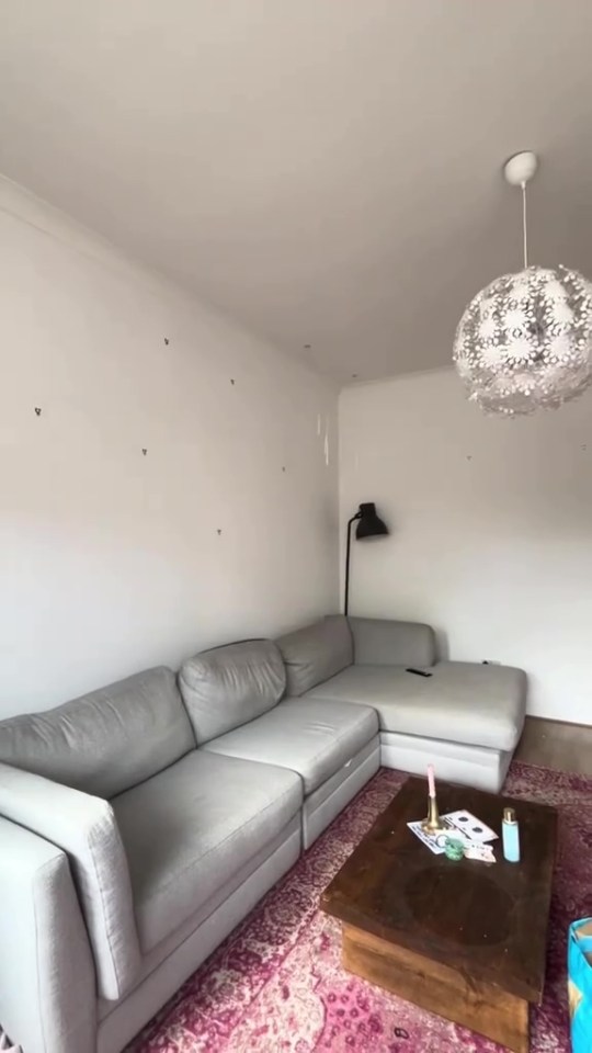 Living room with grey sectional sofa and coffee table.