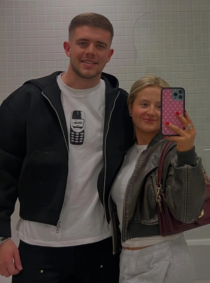 Selfie of a young couple in a bathroom.