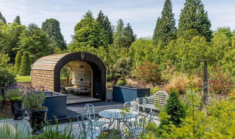 Outdoor sauna with seating area.
