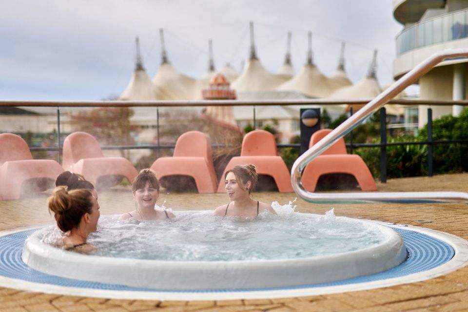 Three women relaxing in a hot tub.
