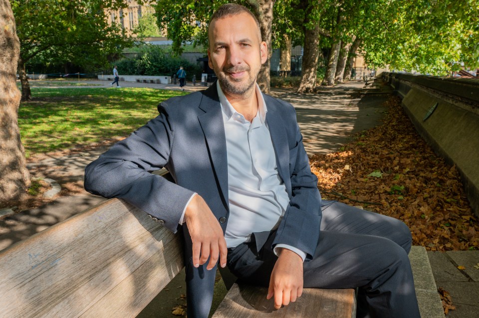 Zack Polanski, Green Party leader, sitting on a park bench.
