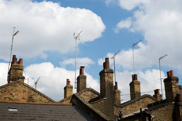 Row of old London houses features traditional brick chimney stacks