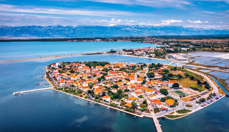 Aerial view of Nin, Croatia, showing the town, lagoon, and Velebit mountains.