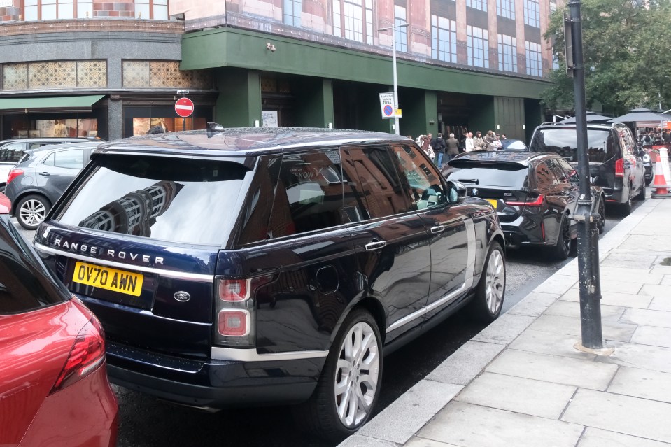 Photo of a dark-colored Range Rover parked on a city street.