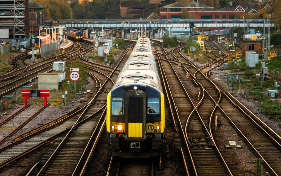 High-angle view of a commuter train approaching a station.