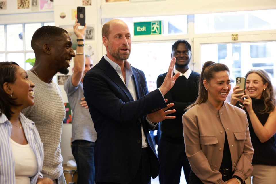 Prince William speaking to a group of young people.