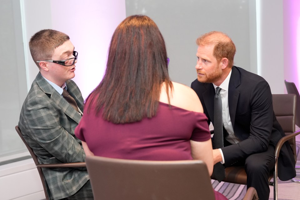 Prince Harry speaking with a young award recipient and their family at the WellChild Awards.
