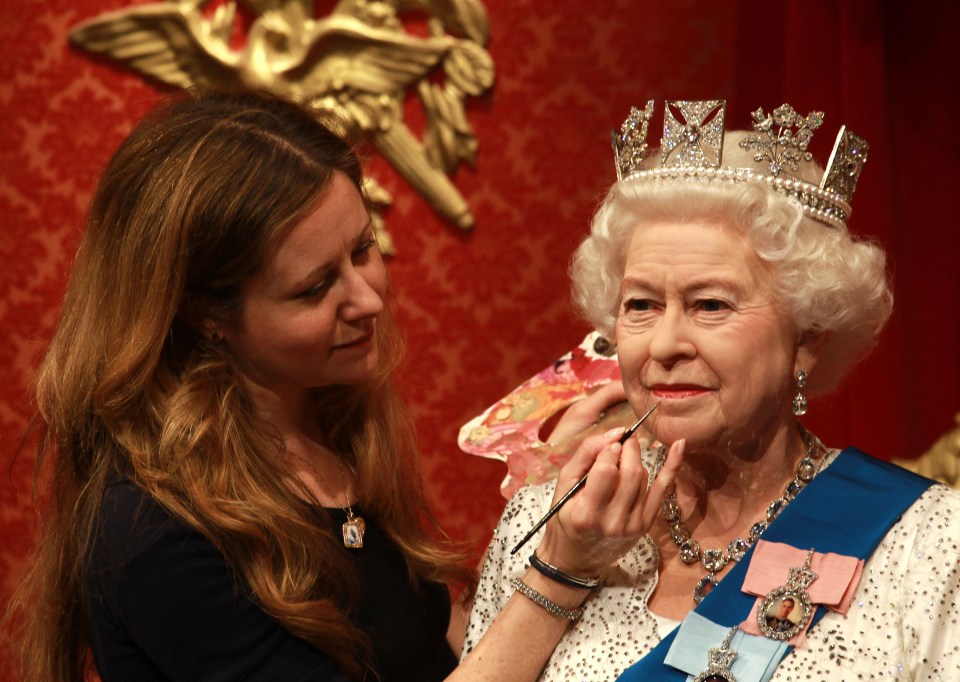 A wax figure of Queen Elizabeth II being retouched at Madame Tussauds London.