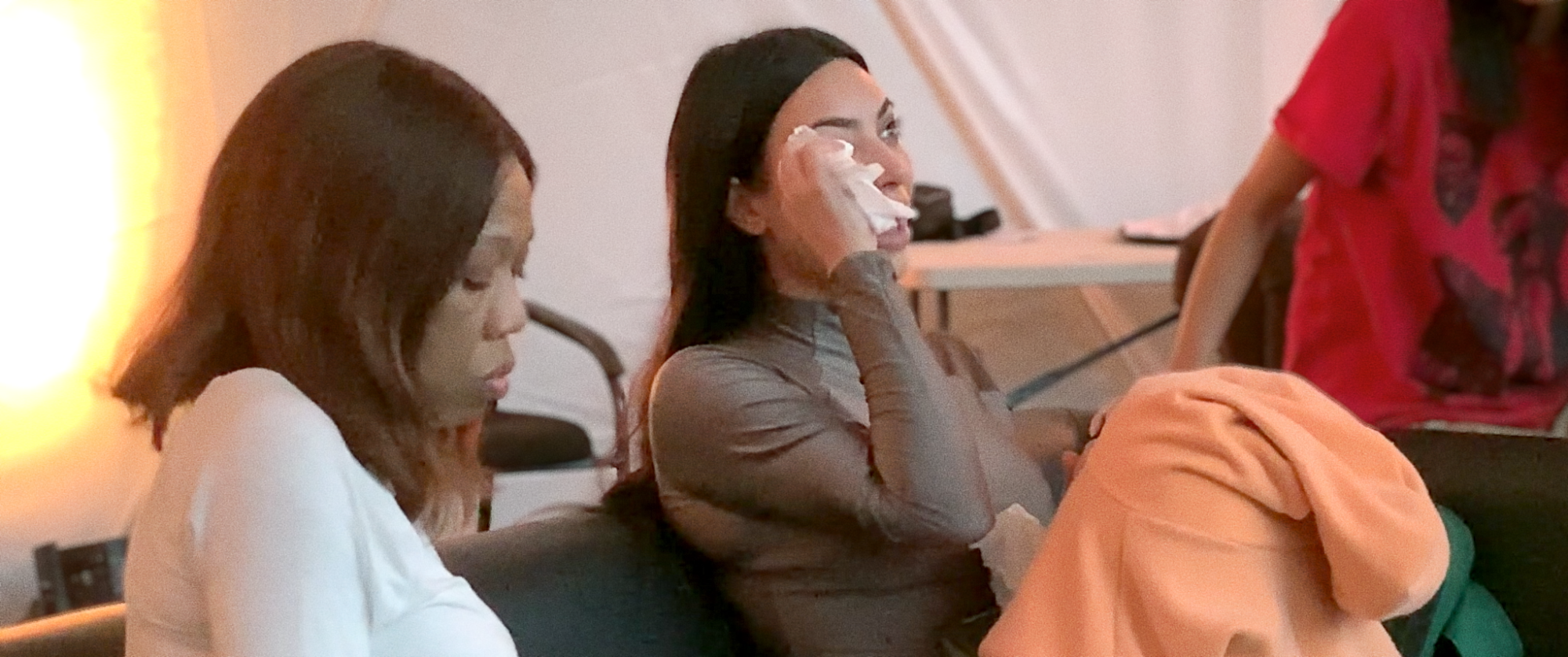 A woman dabs away tears during a fight.