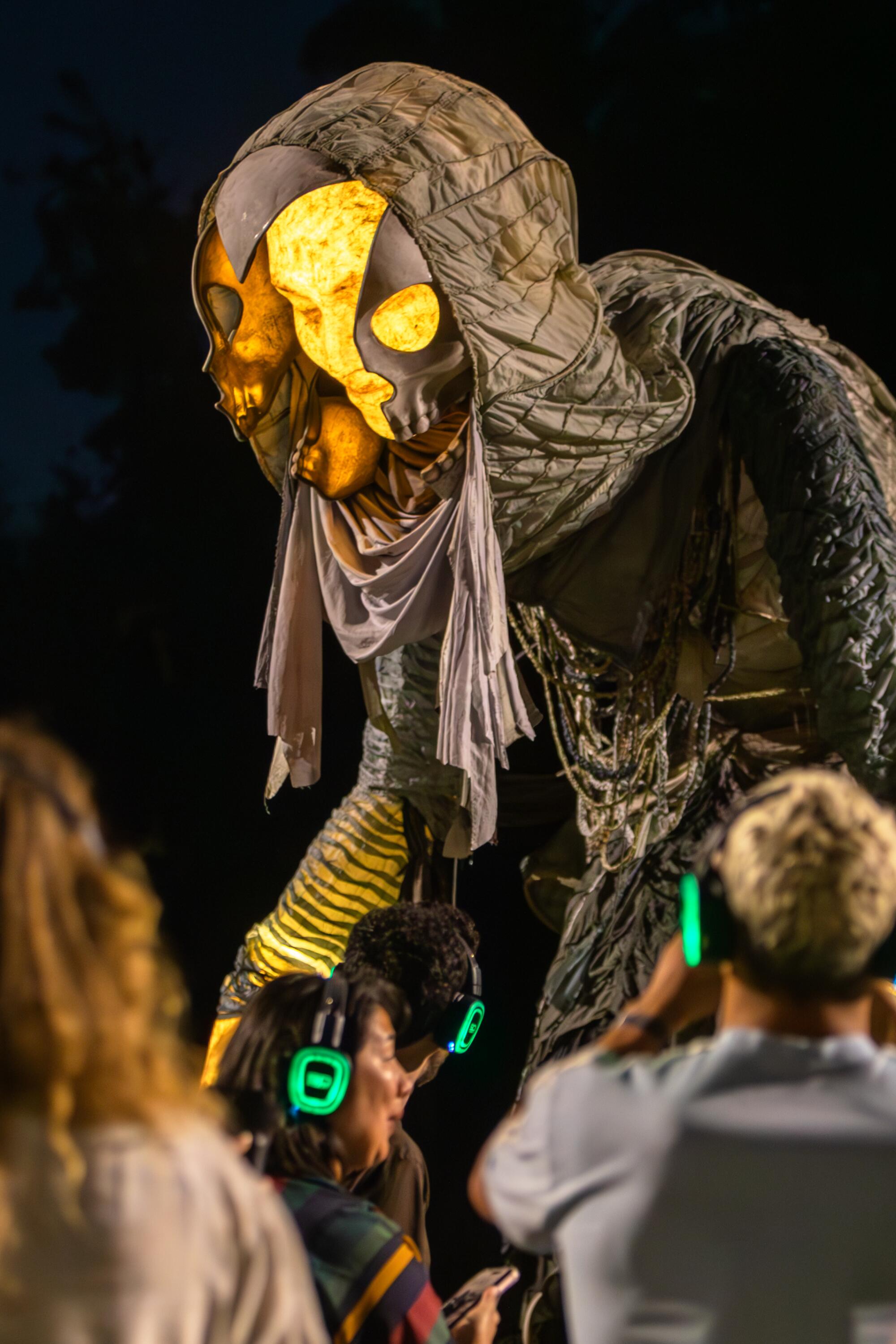 A skeletal-like puppet on a field. 