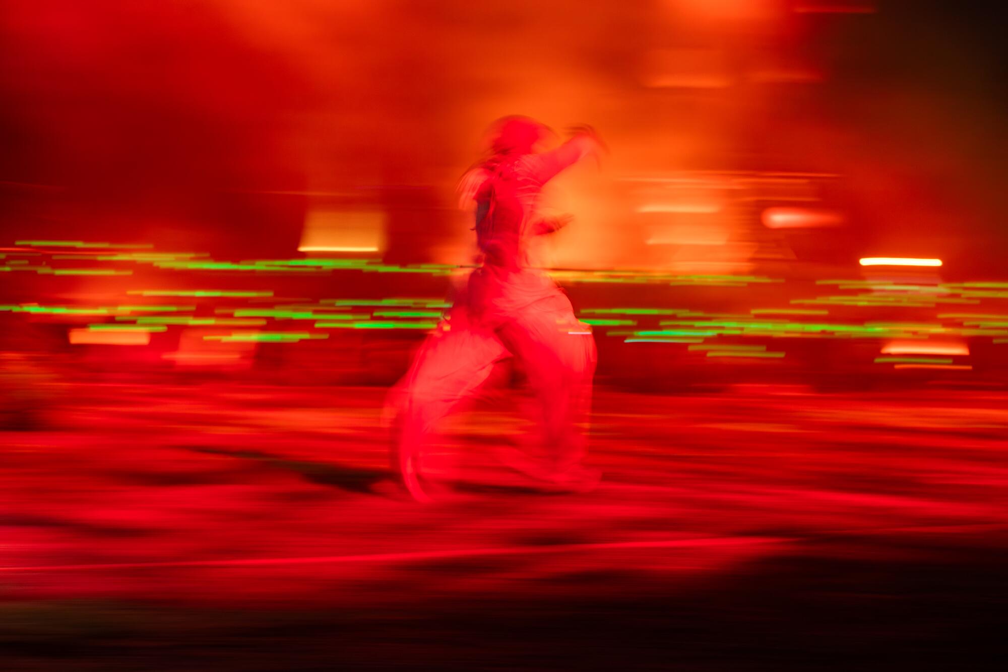 A dancer blurred by light