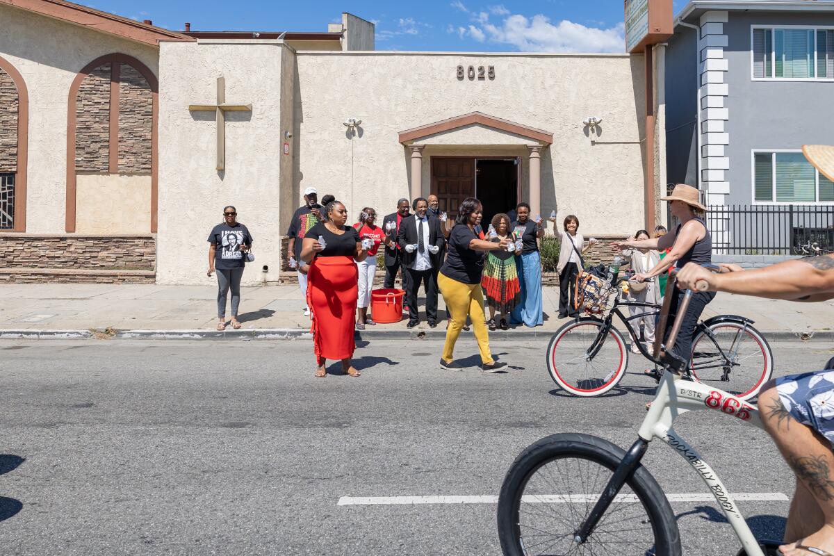 Churchgoers pass out water to cyclists at a previous CicLAvia event.