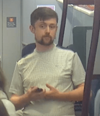 Man on train looking at phone.