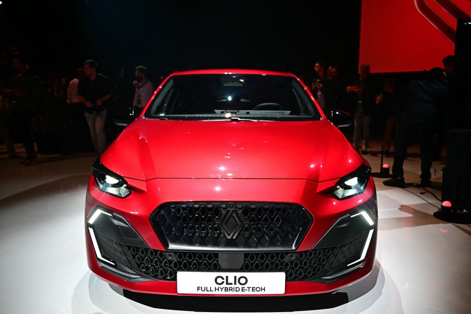 Front view of a red Renault Clio full hybrid E-Tech car.
