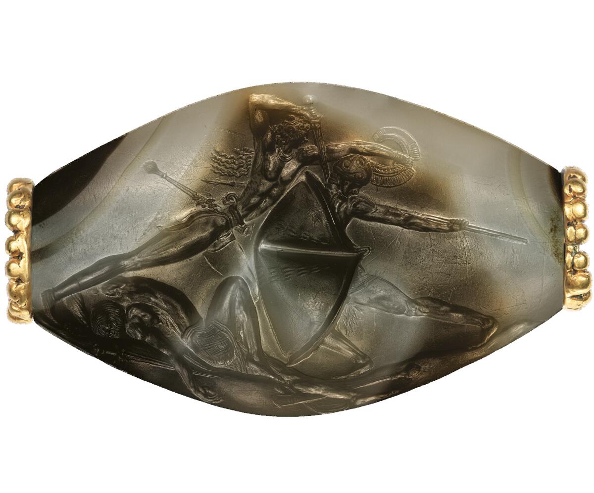 A carved agate stone, banded with gold and bronze.