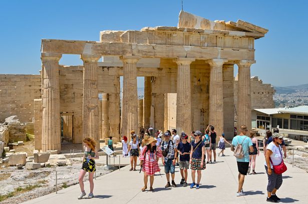Athens, Greece - 27 May 2022: Tourists visiting The Acropolis in Athens