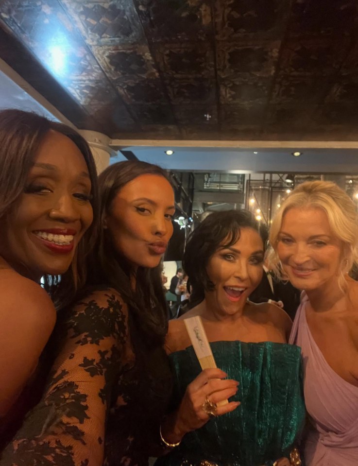 Four women at an awards ceremony.