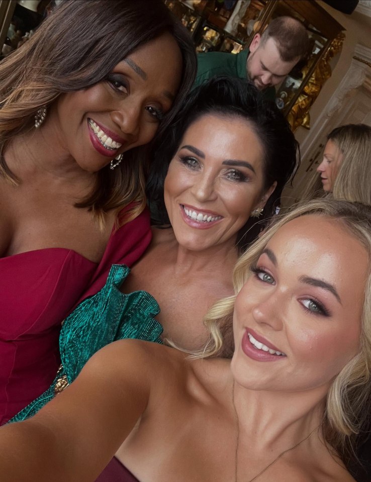 Three women smiling for a selfie.