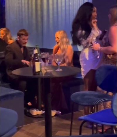 Jess Harding with a group of people at a table.