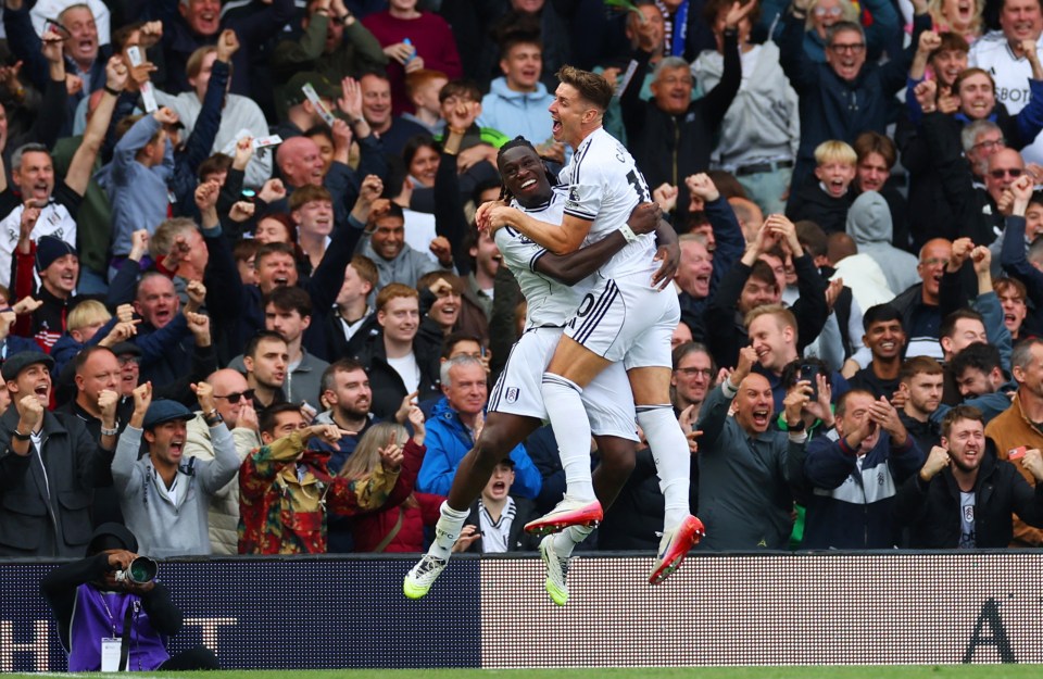 Fulham's Calvin Bassey and Tom Cairney celebrating a goal.
