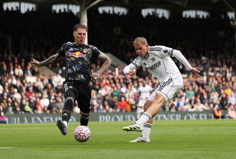 A soccer player kicking the ball during a Fulham vs Leeds United match.