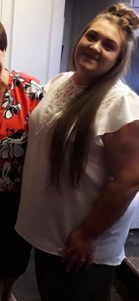 Photo of a woman in a white top.