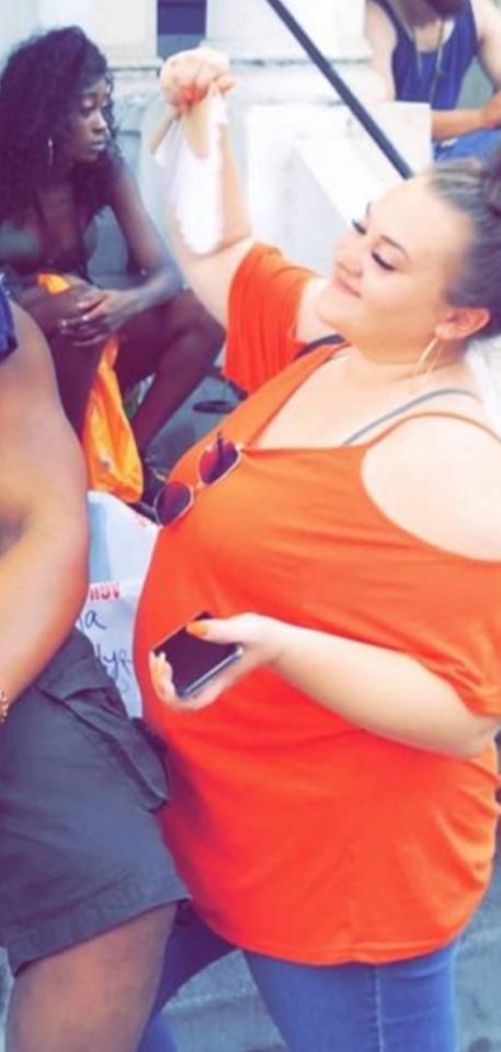 Woman holding a small bag, during her weight loss journey.