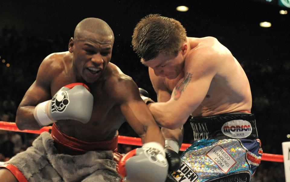 Floyd Mayweather Jr. knocks down Ricky Hatton in a boxing match.