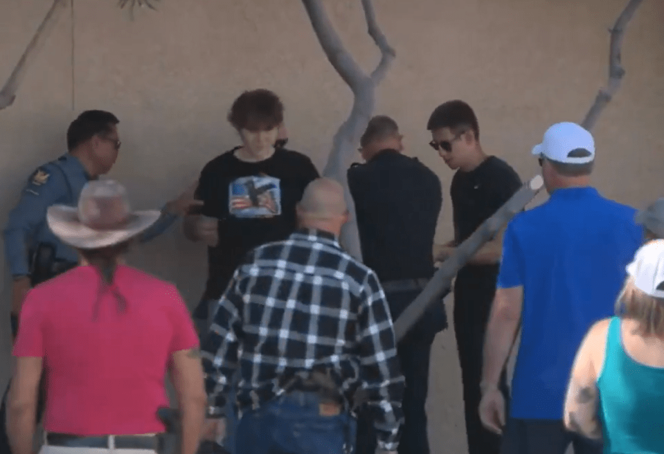 Police officers detaining a person.